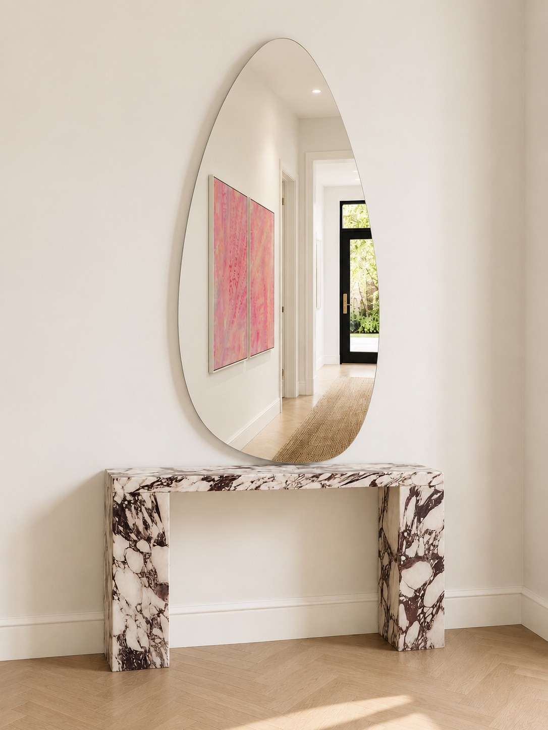 Sculptural mirror installed above a marble console