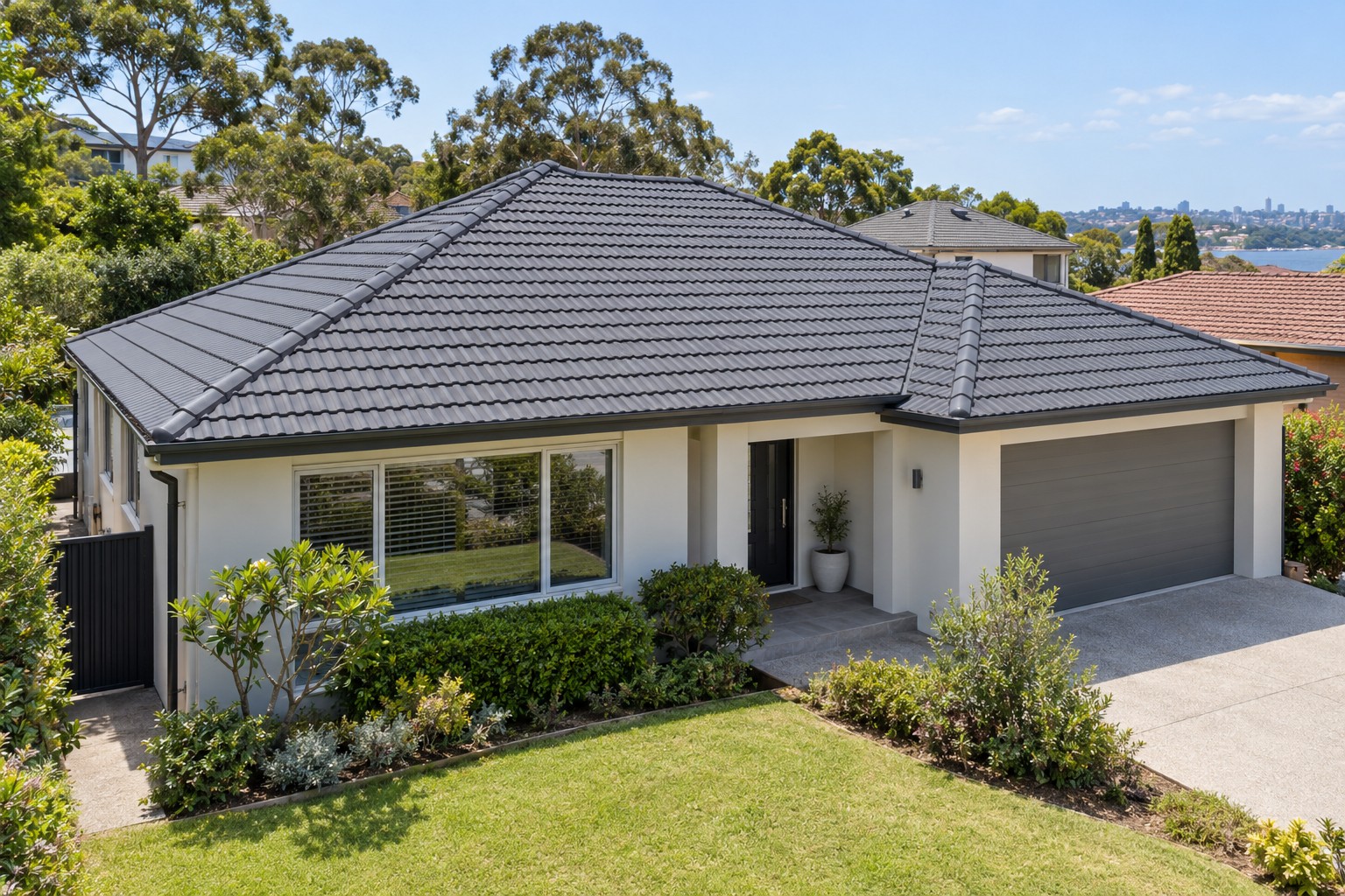 Finished charcoal tiled roof with the home in view