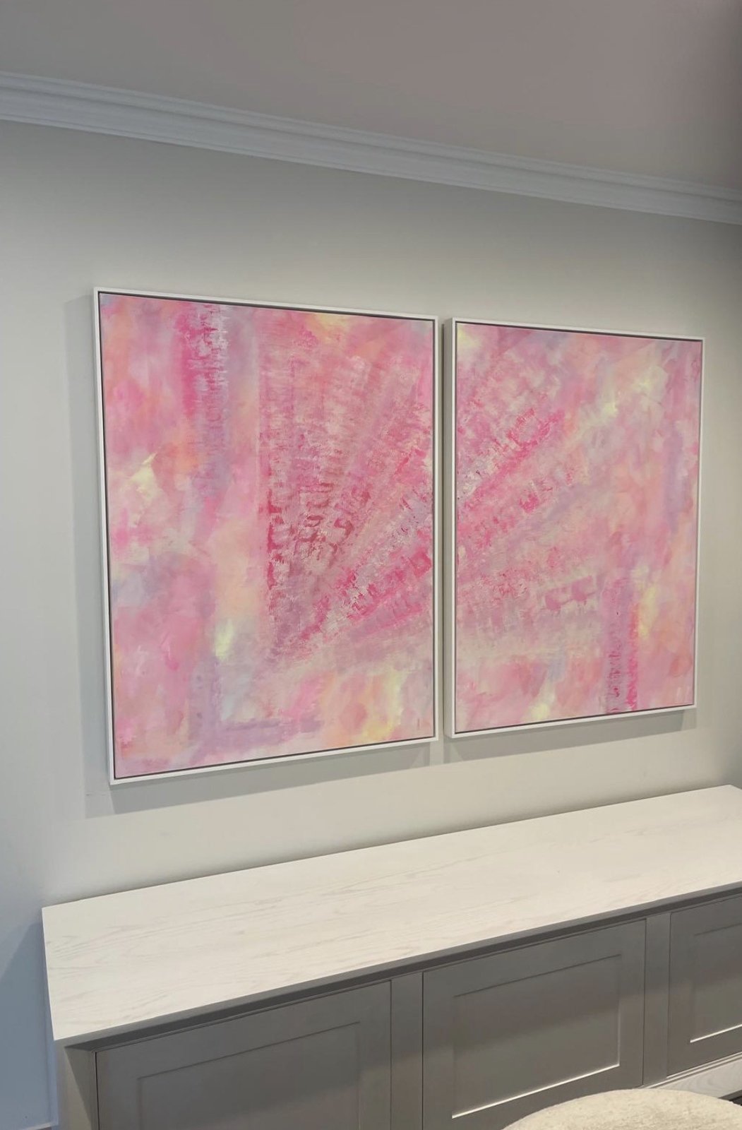 Paired abstract artworks installed above joinery