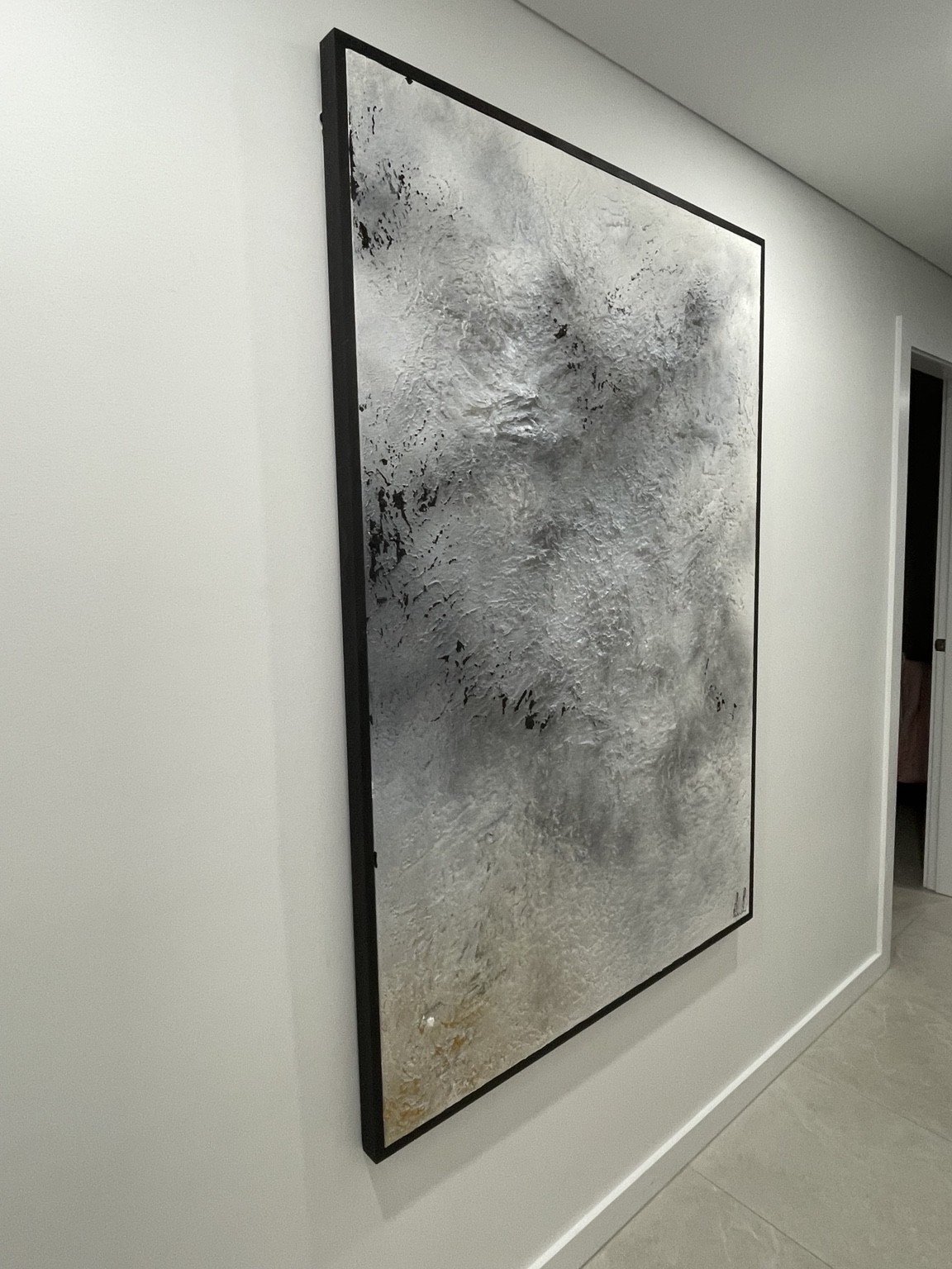 Monochrome artwork installed in a hallway