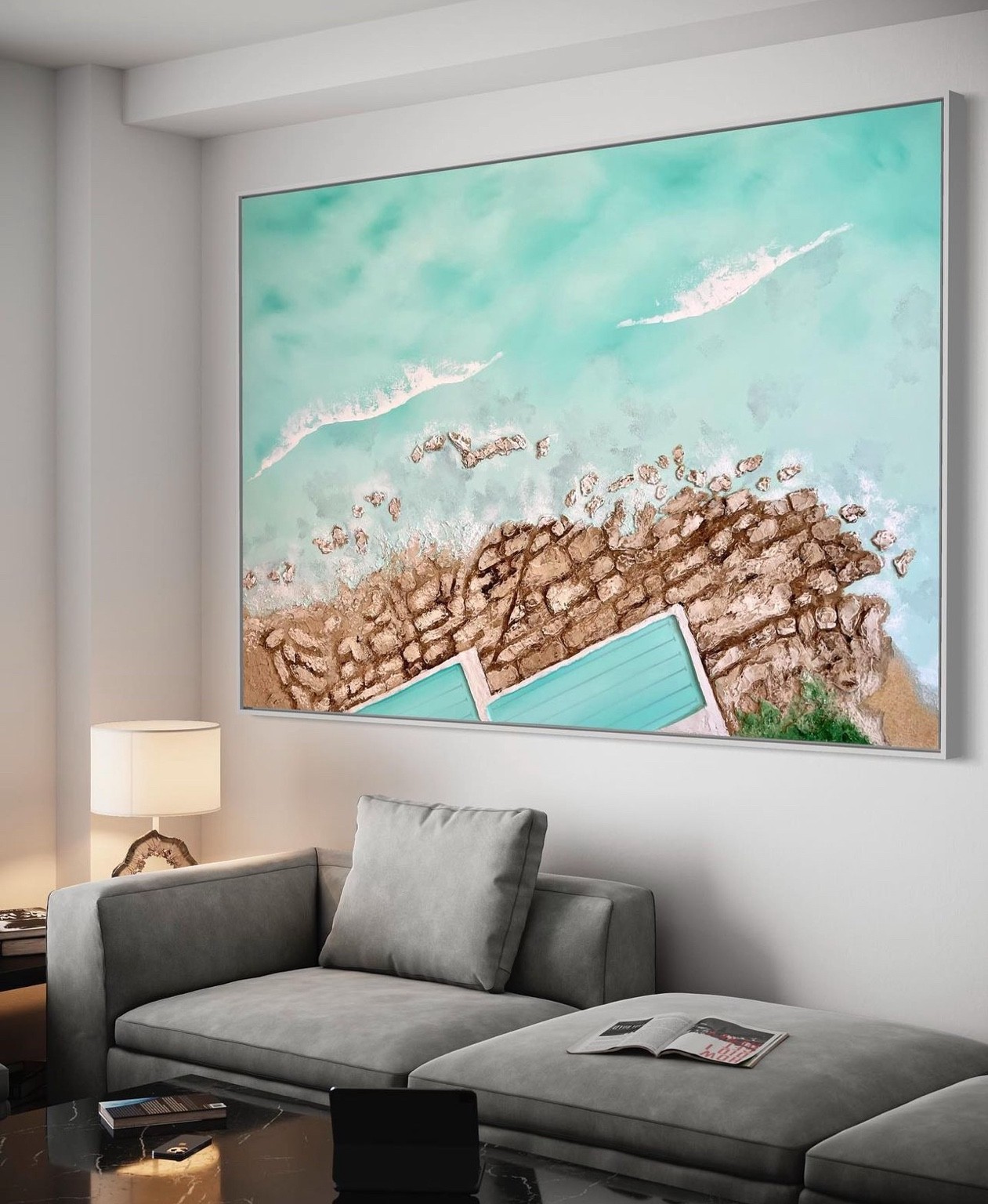 Large coastal artwork installed above a sofa
