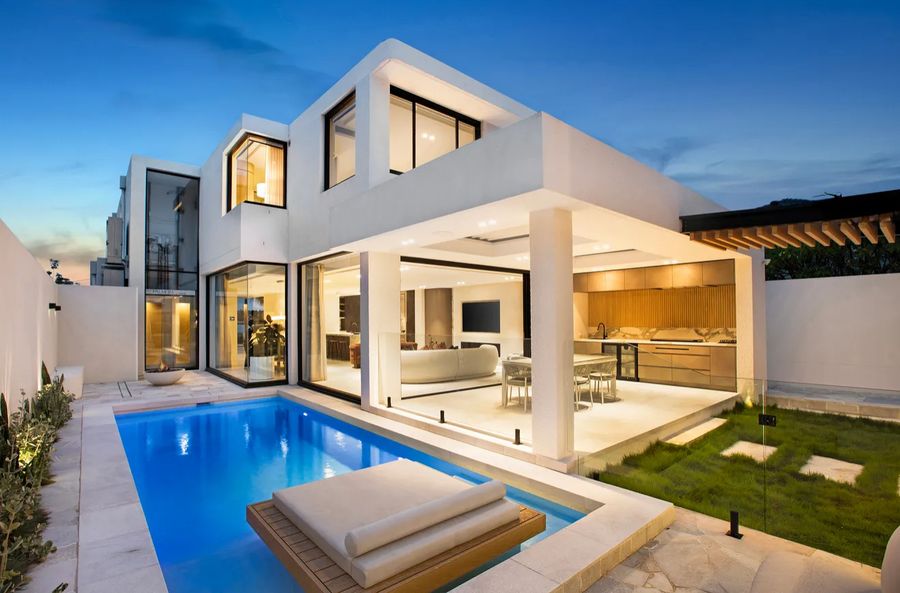 Rendered rear facade and pool at dusk