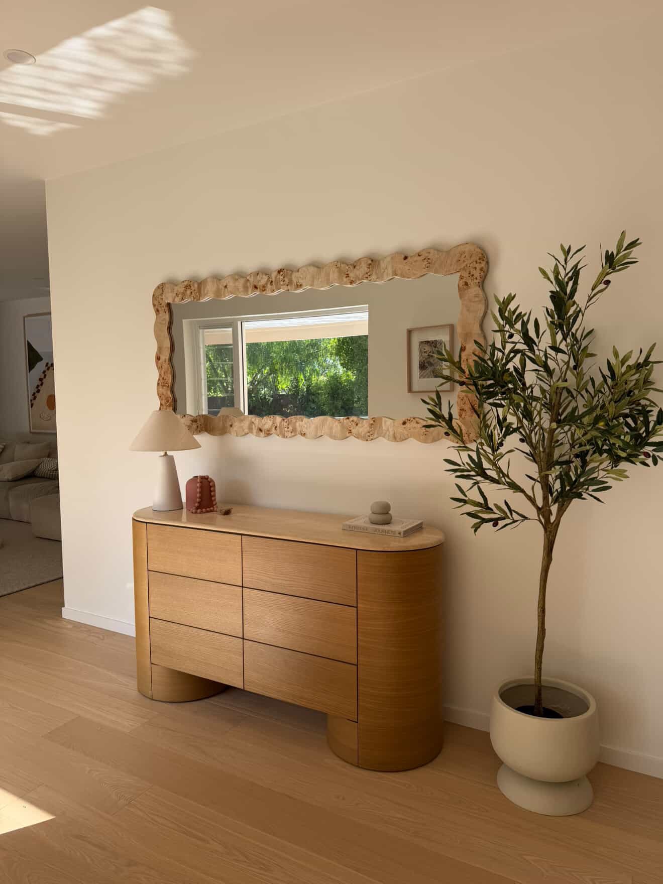 Feature mirror installed above a timber dresser